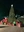 Illuminated Christmas tree surrounded by colorful gifts and holiday decorations.