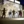 People stand in front of the large mural at La Sierra University, casting shadow silhouettes on the vibrant artwork adorning the art department wall