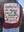A woman's shirt bears the inscription, "Our struggles as women begin by recognizing the struggles of girls."
