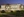 A nighttime photo of the Tom &amp; Vi Zapara School of Business.