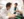 Two La Sierra students in lab coats are engaged in a discussion while working in a laboratory. One is leaning over a table, while the other holds lab equipment. The setting includes various scientific instruments and lab supplies